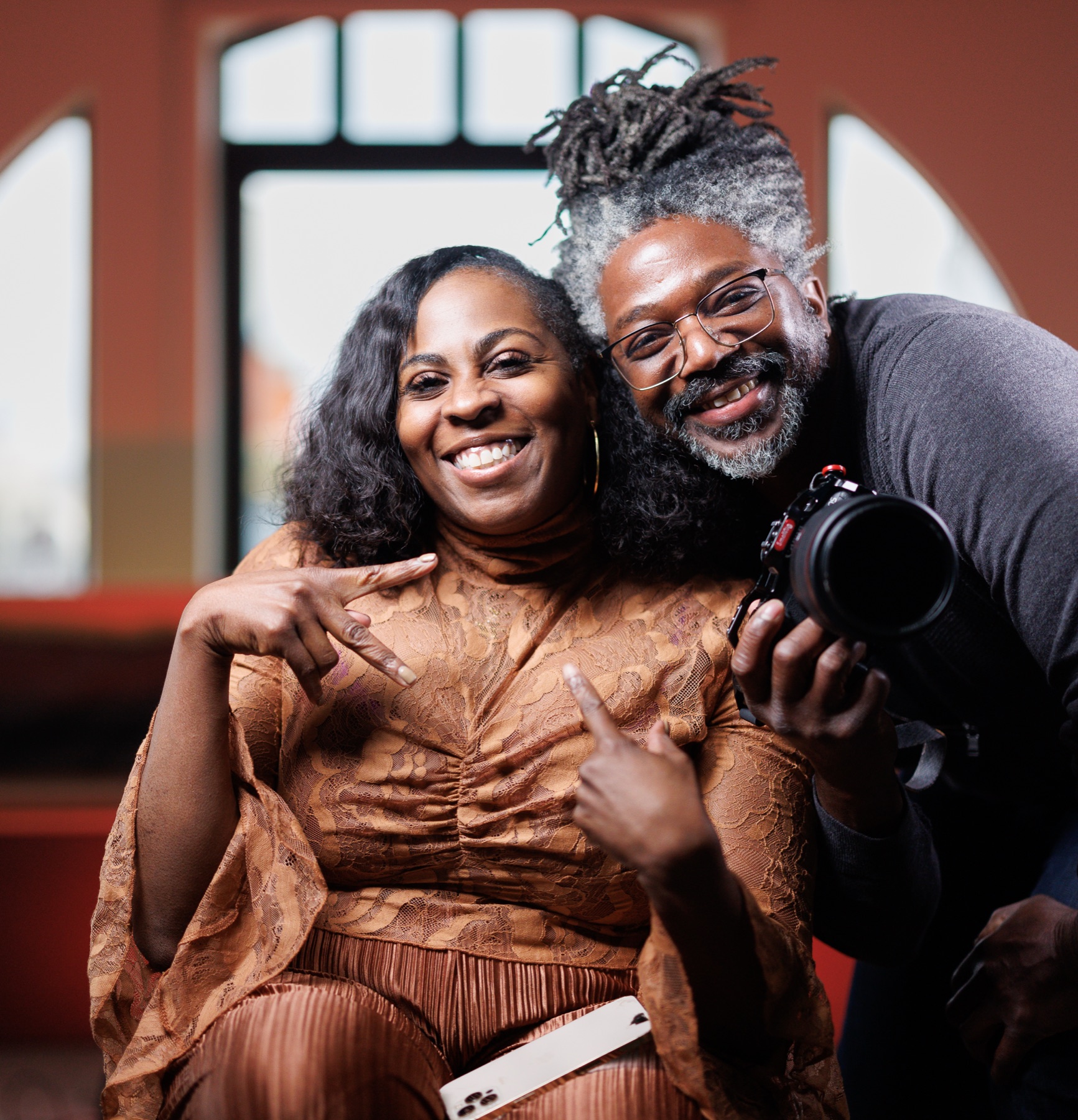 Kevan laughing with a client, camera in hand